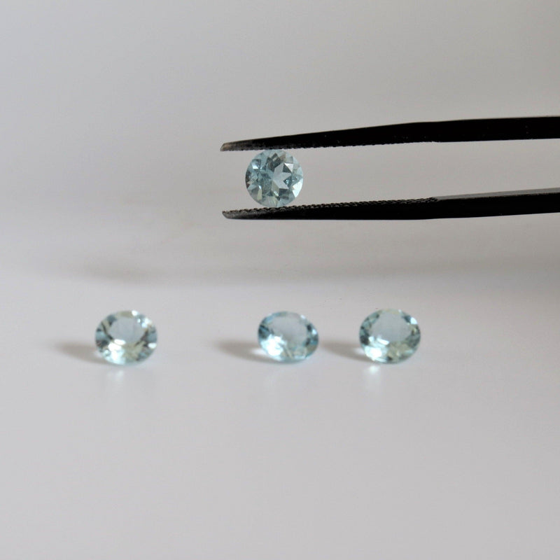 5.1mm Round Aquamarine Stone with tweezer view - cape diamond exchange