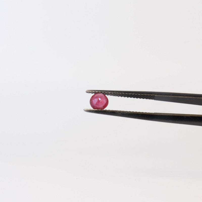 5.2mm Round Ruby Stone with tweezer view - cape diamond exchange