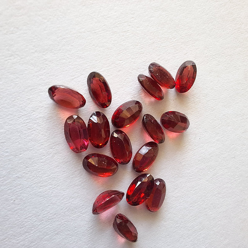 Garnet gemstones on a textured white surface, Cape Town, South Africa