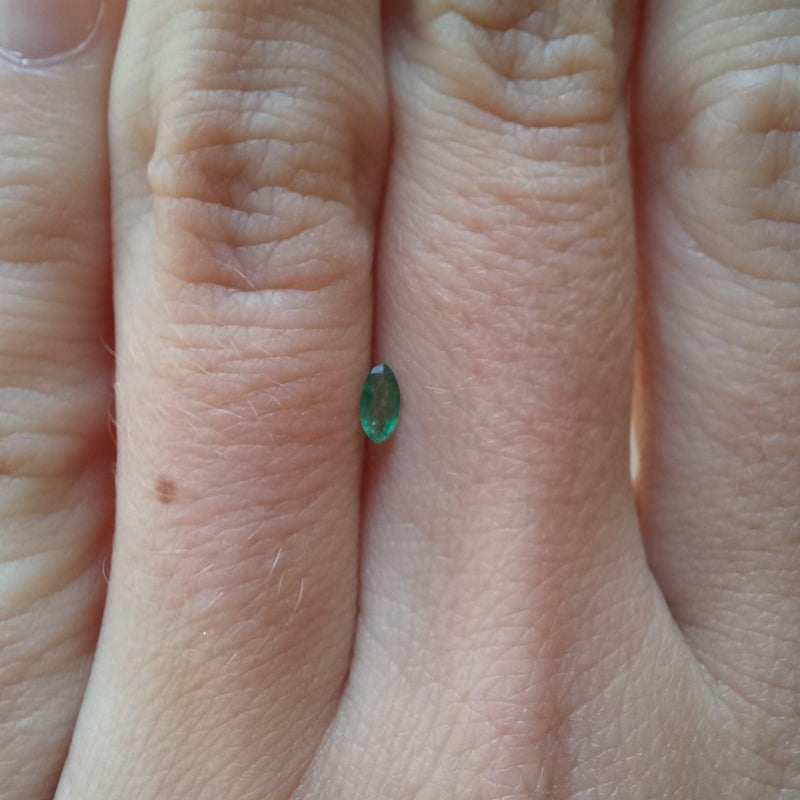 0.09ct Marquise Emerald stone with finger view - cape diamond exchange