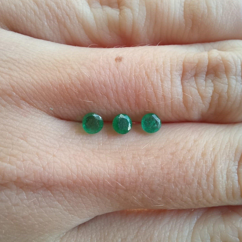 0.2ct Round Emerald Stone with finger view - cape diamond exchange