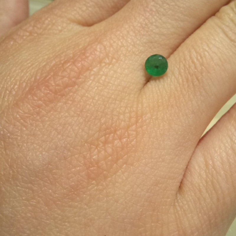 0.33ct Round Emerald Stone with finger view - cape diamond exchange