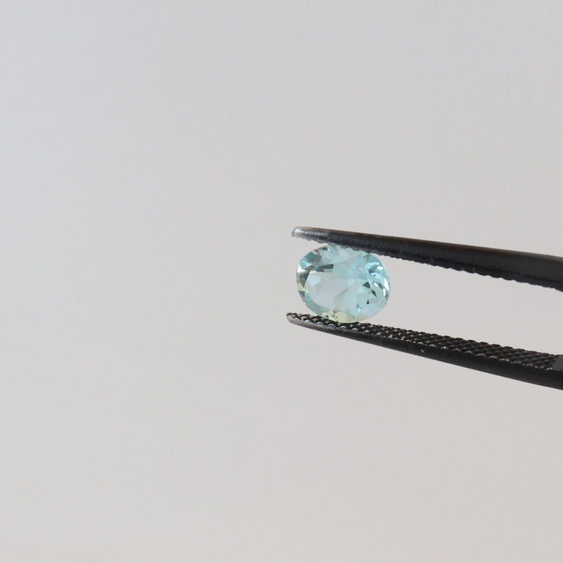 0.73ct Blue Sky Oval Topaz Stone with tweezer view - cape diamond exchange