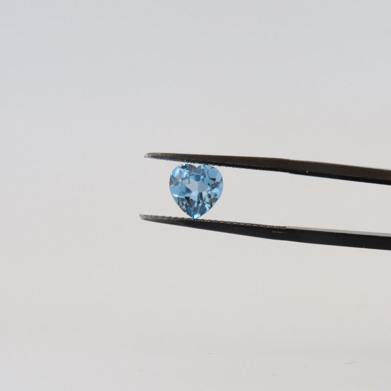 1.55ct Heart Shaped London Blue Topaz Stone with tweezer view - cape diamond exchange