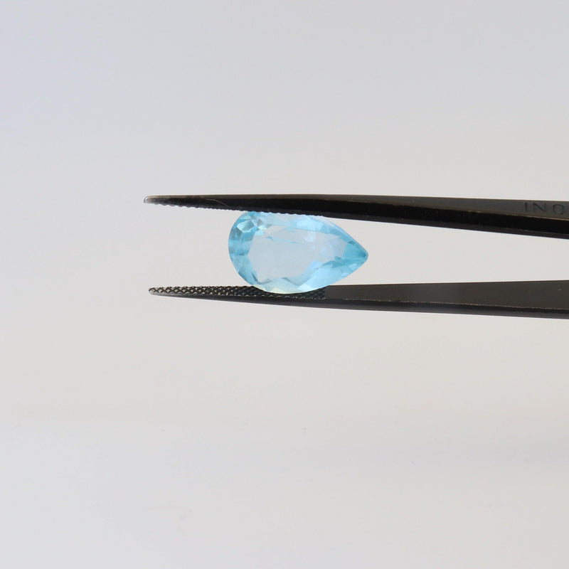 10mmx15mm Sky Blue Pear Shape Topaz Stone with tweezer side view - cape diamond exchange