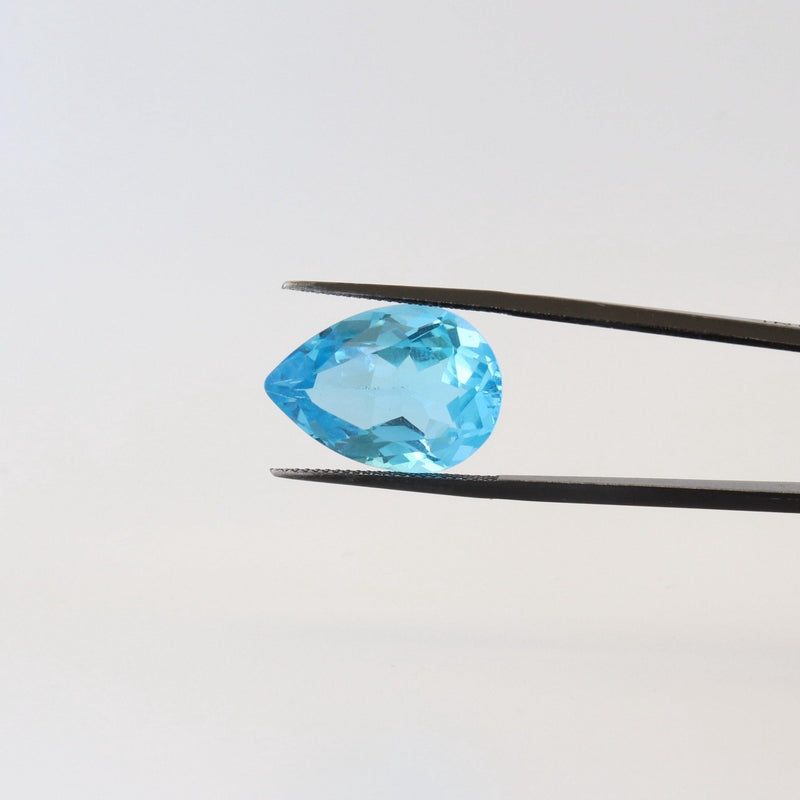 14.7ct Swiss Blue Pear Shape Topaz Stone with tweezer view - cape diamond exchange