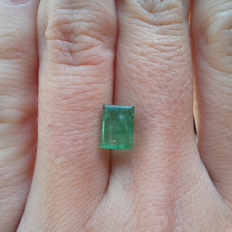 15.85ct Emerald Stone with finger light view - cape diamond exchange