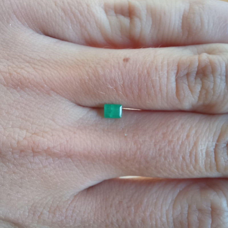 0.24ct Emerald Stone with finger view - cape diamond exchange