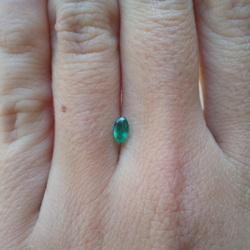 3mmx5mm Oval Emerald Stone with finger view - cape diamond exchange