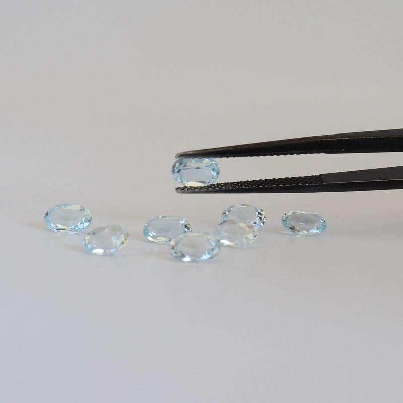 4mmx6mm Oval Sky Blue Topaz with tweezer view - cape diamond exchange