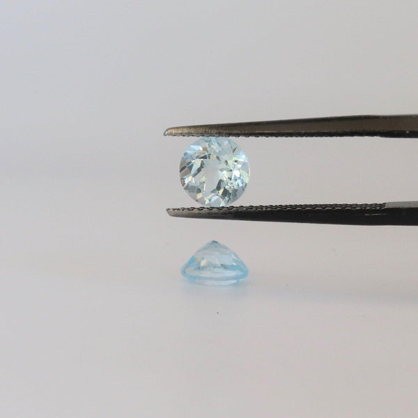 6.3mm round Blue Topaz Stone with bottom and front view - cape diamond exchange