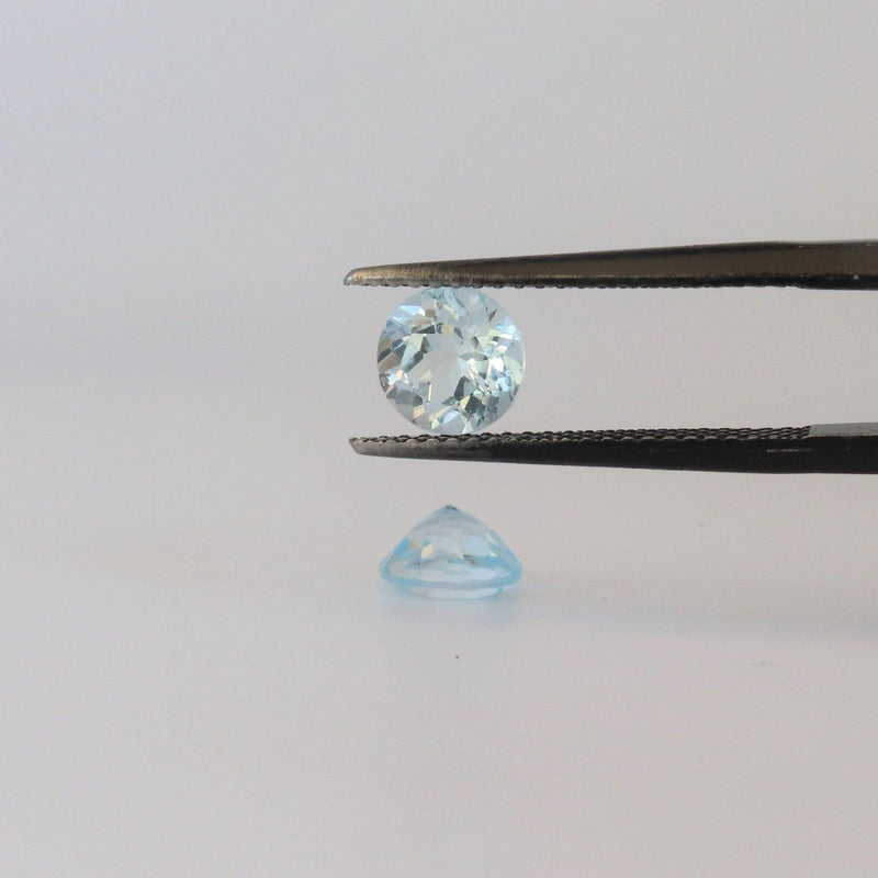 6.3mm round Blue Topaz Stone with bottom and front view - cape diamond exchange