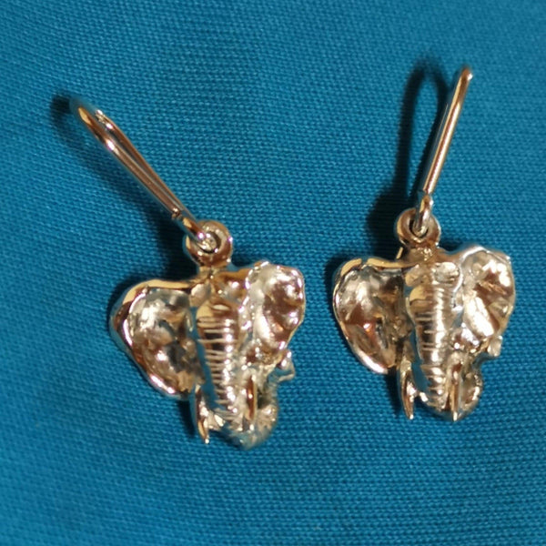 Elephant face earrings hang from the earlobes and sit nicely parallel to your face.  The elephant’s face has strong features and is very detailed. This set of earrings moves from side to side, back, and front with your face…Cape Diamond Exchange