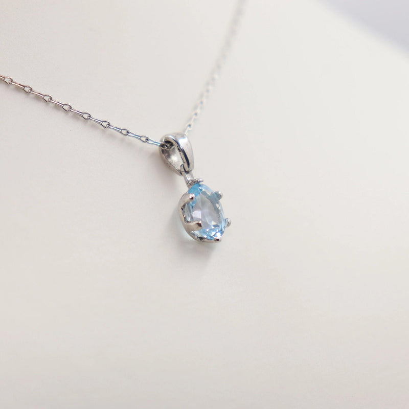 Four Claw Oval Blue Topaz Pendant set in White Gold