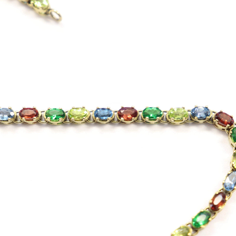 Peridot, Topaz and Garnet Tennis Bracelet set in 9 kt Yellow Gold