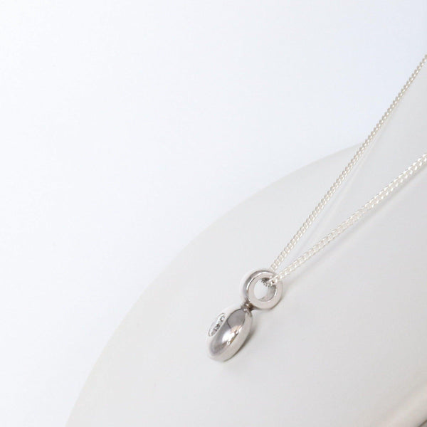 Platinum doughnut pendant with a diamond side view - Cape Diamond Exchange