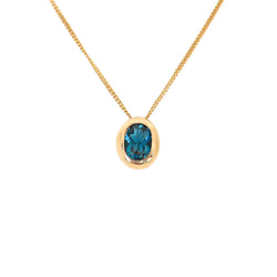 Oval Blue Topaz Pendant set in 9 kt Yellow Gold
