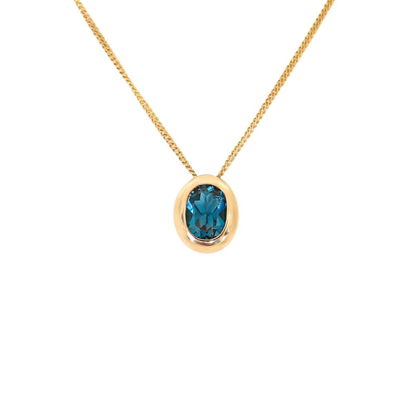Oval Blue Topaz Pendant set in 9 kt Yellow Gold